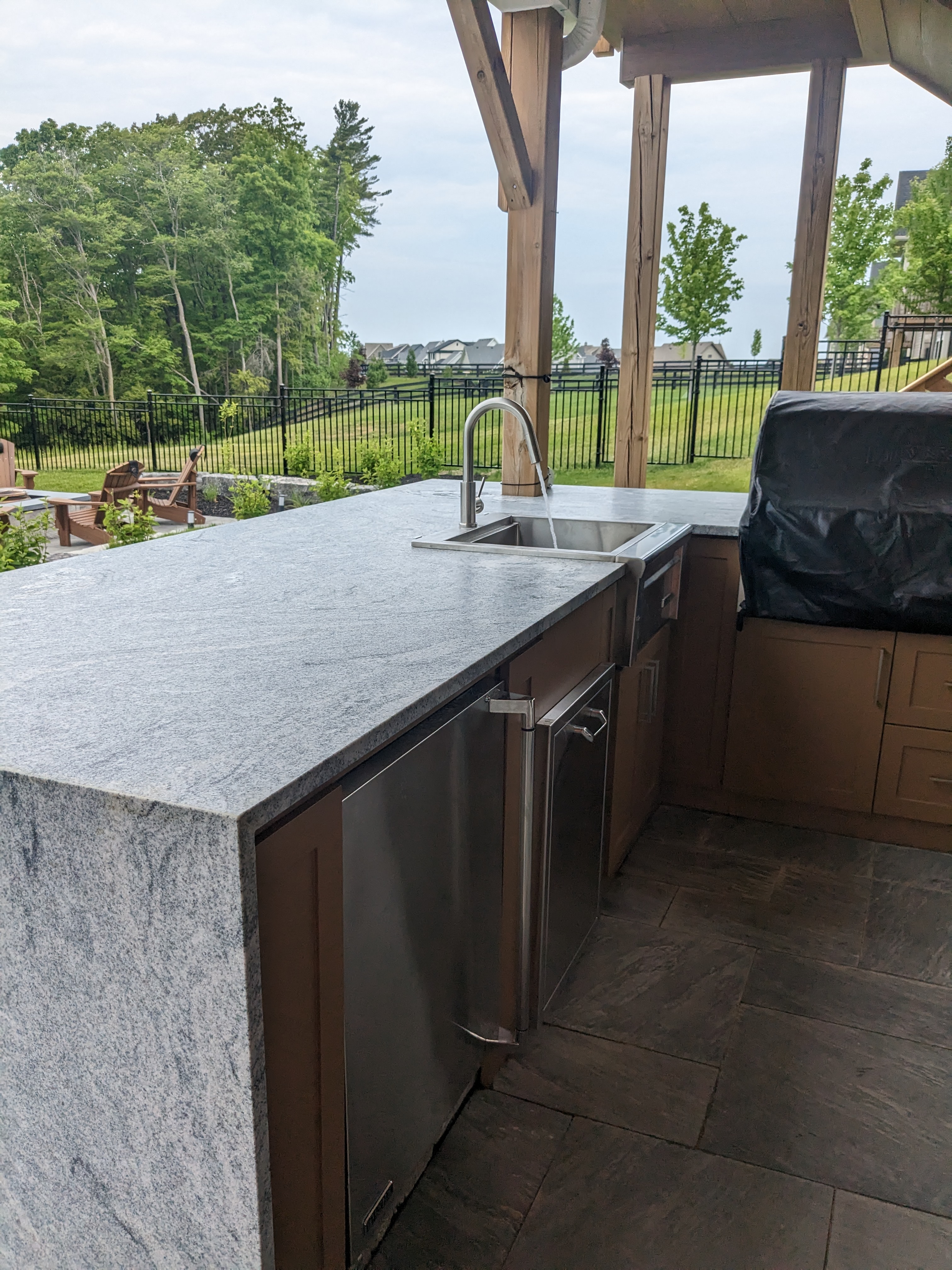 Outdoor kitchen with built in fridge and BBQ
